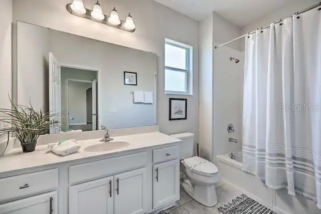 full bathroom with vanity, tile floors, shower / bath combo with shower curtain, and toilet