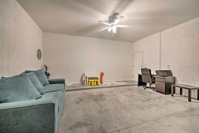 home theater room with a textured ceiling and ceiling fan