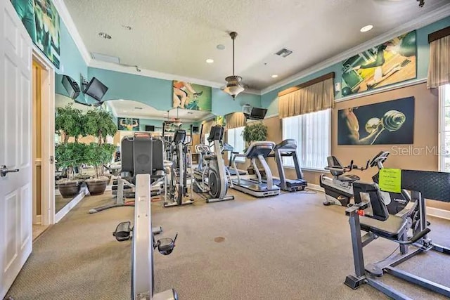 workout area with light carpet, ornamental molding, and a textured ceiling