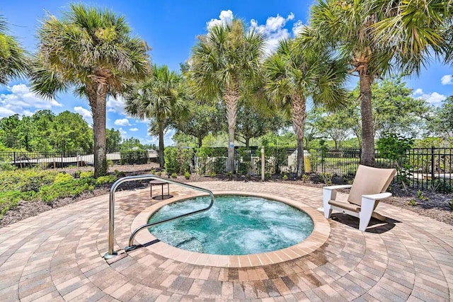 view of swimming pool featuring a patio area and an in ground hot tub