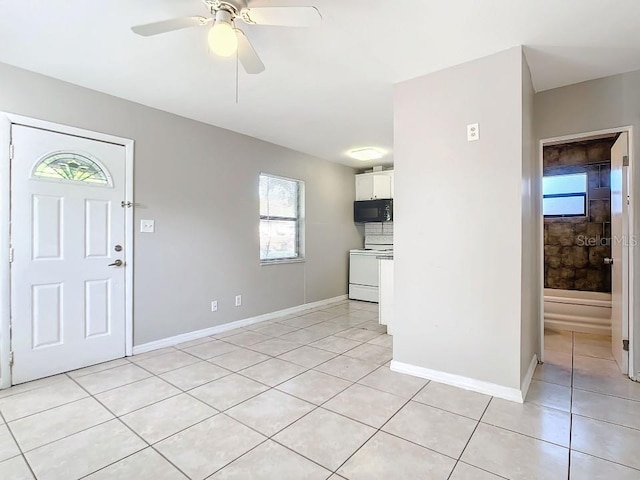 foyer with a healthy amount of sunlight, ceiling fan, and light tile floors