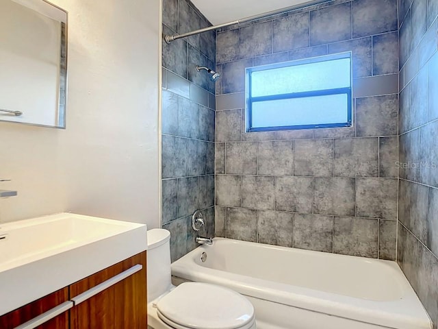 full bathroom with vanity, toilet, and tiled shower / bath