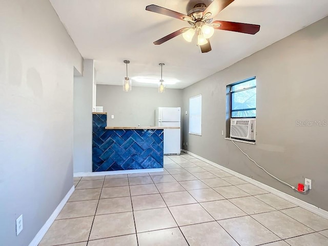 interior space with light tile floors and ceiling fan