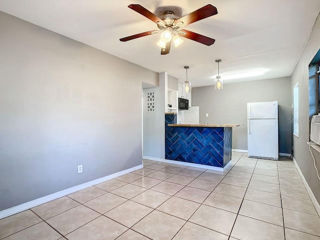 tiled empty room featuring ceiling fan