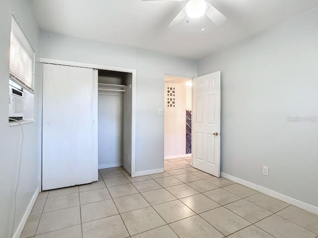 unfurnished bedroom with light tile floors, a closet, and ceiling fan