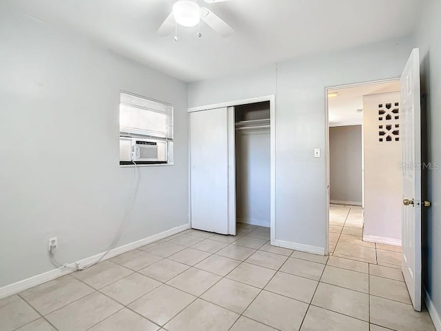 unfurnished bedroom featuring light tile floors, a closet, and ceiling fan