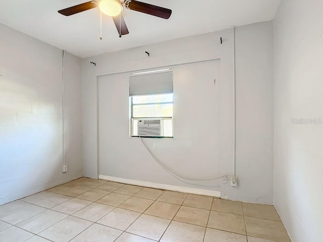 tiled empty room featuring ceiling fan