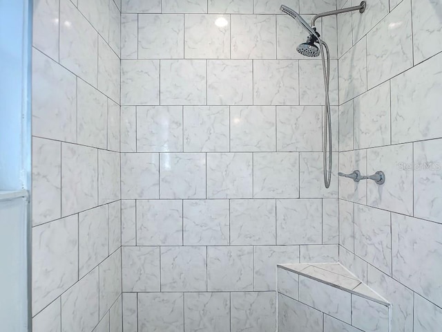 bathroom with a tile shower