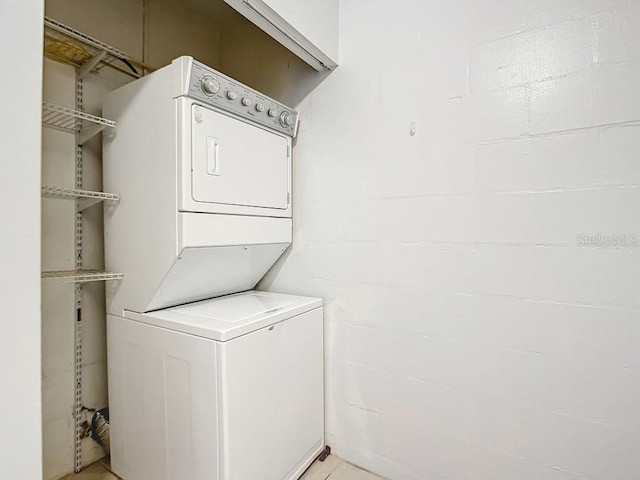 clothes washing area with stacked washer / drying machine