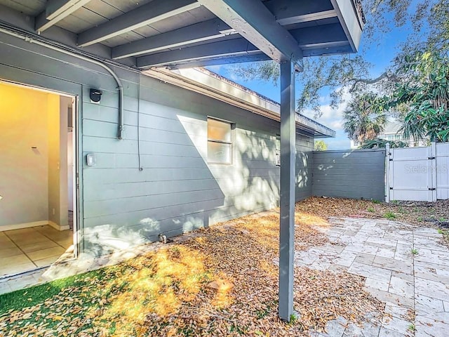 view of property exterior with a patio area