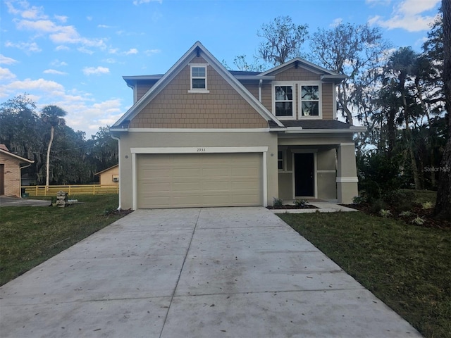 view of front of home with a garage and a front lawn