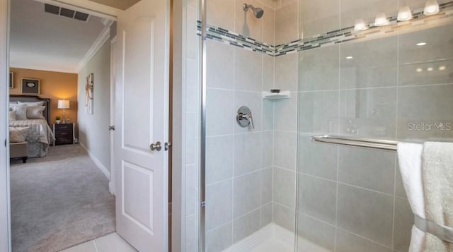 bathroom featuring tile patterned flooring, crown molding, and walk in shower