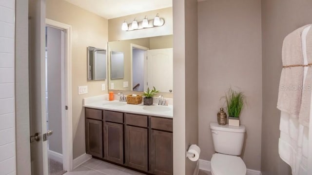 bathroom featuring vanity, toilet, and tile patterned flooring