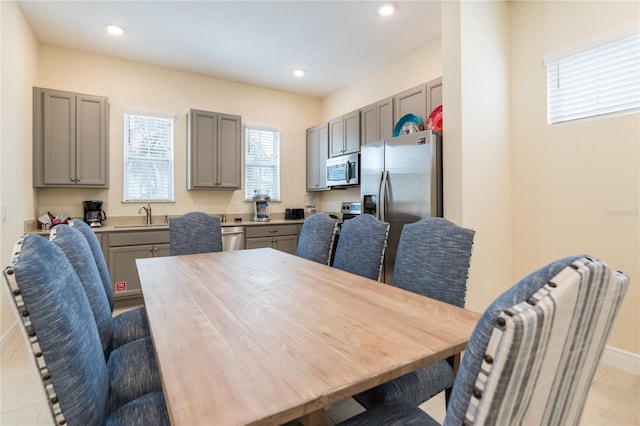 dining area with sink and light tile floors