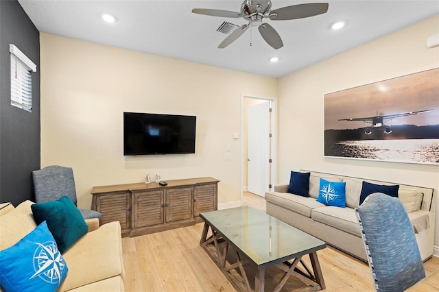 living room with ceiling fan and light hardwood / wood-style flooring