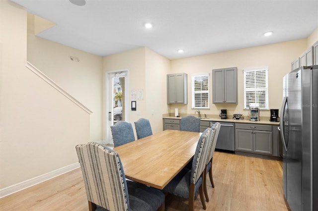 dining room with light hardwood / wood-style floors and sink