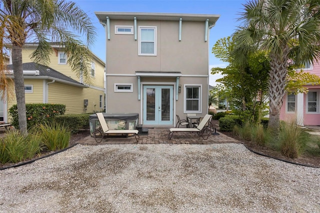 back of house with french doors and a patio