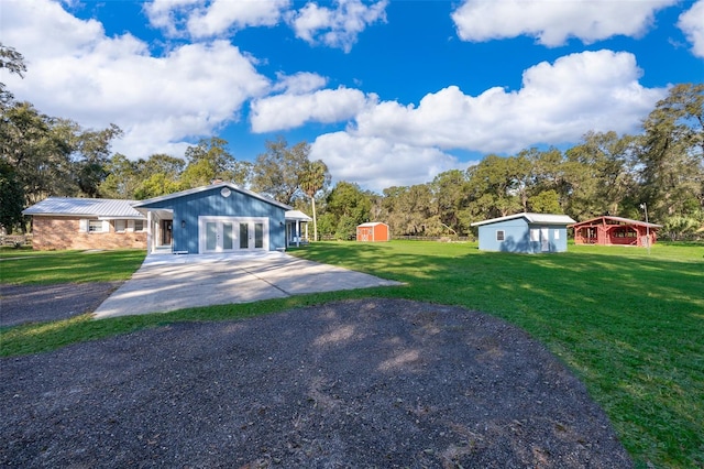 view of front of house featuring an outdoor structure and a front yard