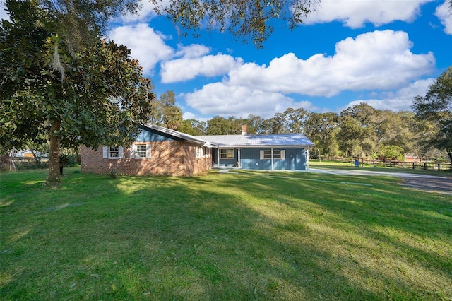 ranch-style home with a front lawn