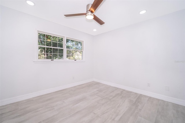 spare room featuring light hardwood / wood-style floors and ceiling fan