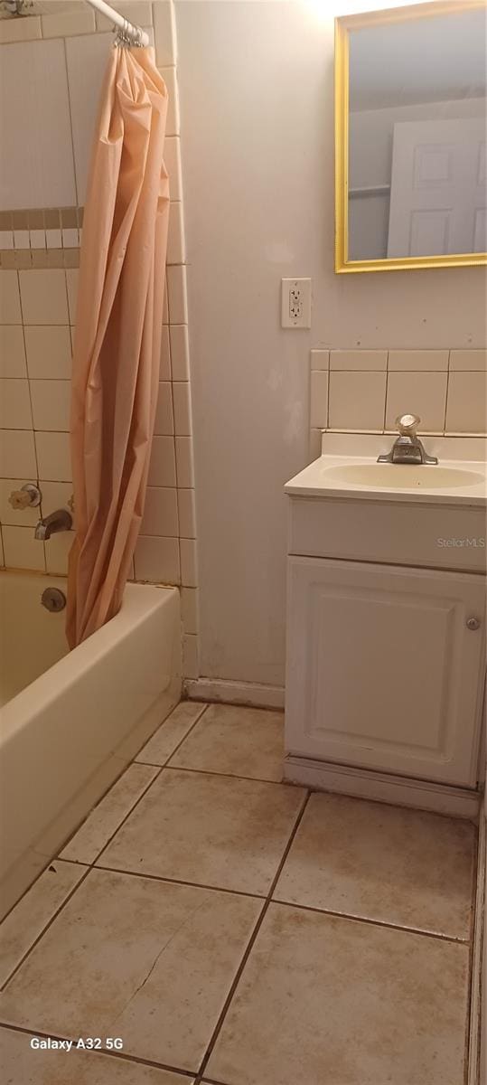 bathroom featuring shower / bath combination with curtain, tile flooring, and vanity