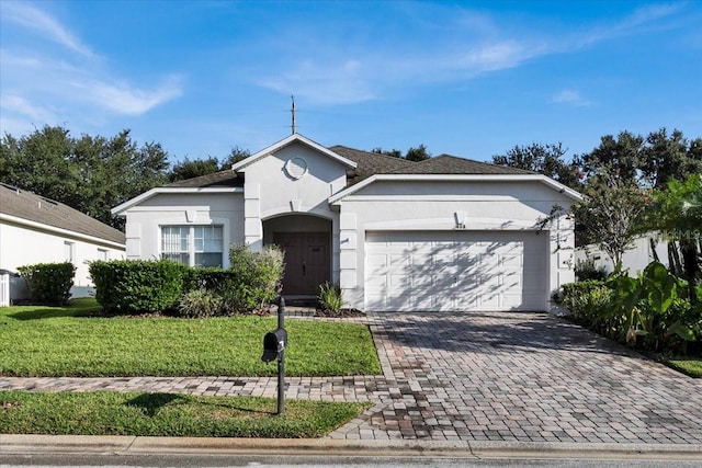 ranch-style home featuring a front lawn and a garage