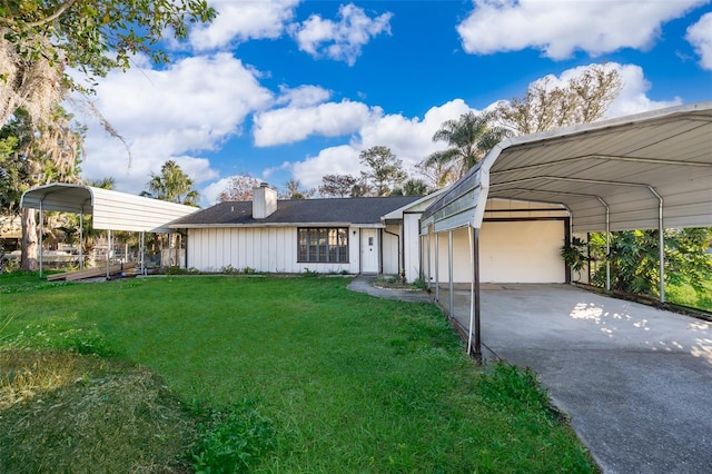 view of front of house featuring a carport, a front lawn, and a garage