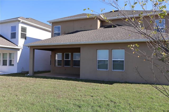 back of house with a yard and a patio