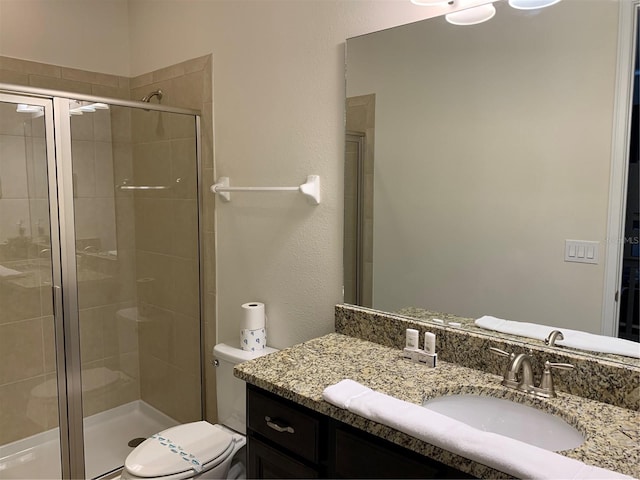 bathroom featuring an enclosed shower, toilet, and vanity