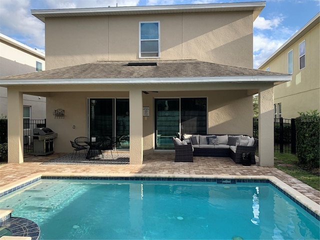 rear view of house with a patio area and outdoor lounge area