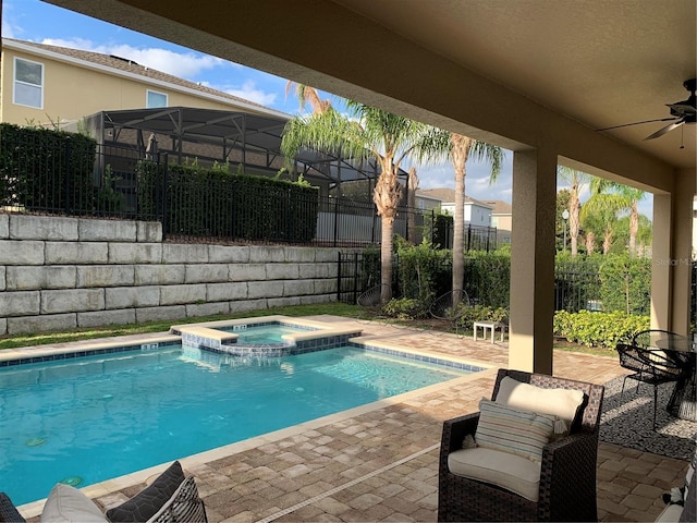 view of pool with ceiling fan, a patio, and an in ground hot tub