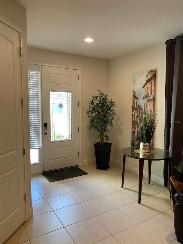 foyer entrance with light tile patterned flooring