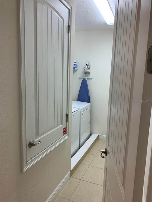 bathroom featuring separate washer and dryer and tile patterned floors