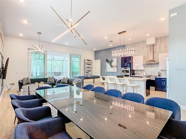 dining area featuring a chandelier and light wood-type flooring