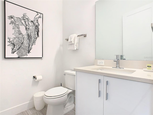 bathroom featuring vanity, tile floors, and toilet