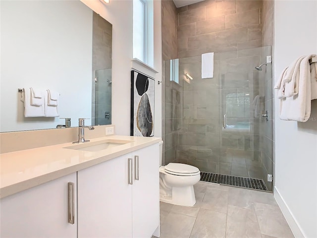 bathroom with tile floors, toilet, walk in shower, and vanity