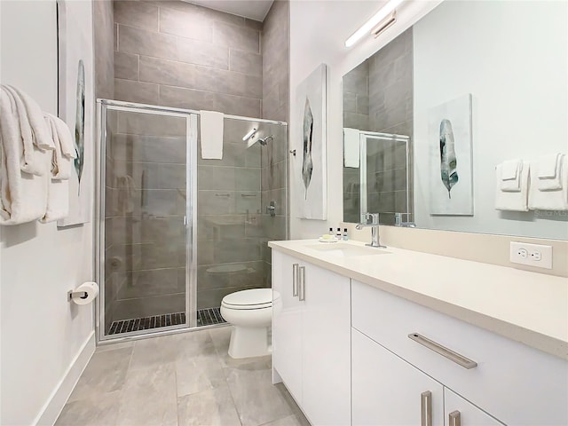 bathroom with a shower with door, tile floors, oversized vanity, and toilet