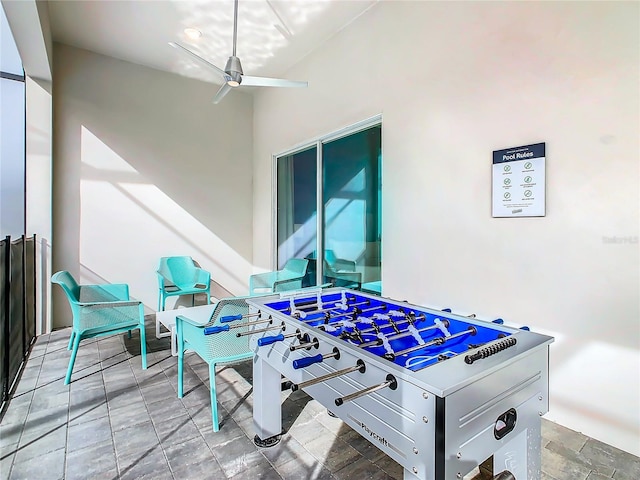 recreation room with ceiling fan and light tile floors