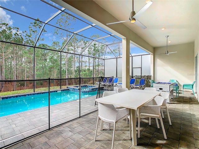 view of pool featuring a patio, ceiling fan, an in ground hot tub, and a lanai