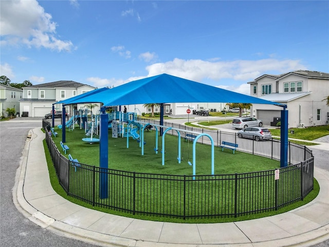 view of property's community featuring a lawn and a playground