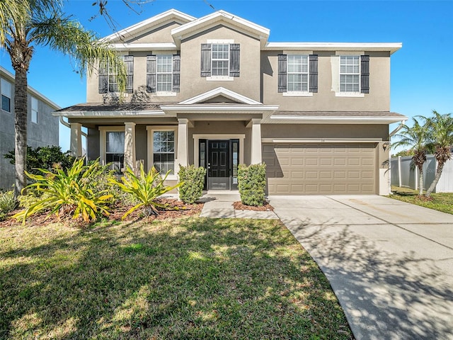 view of front of home with a front yard and a garage