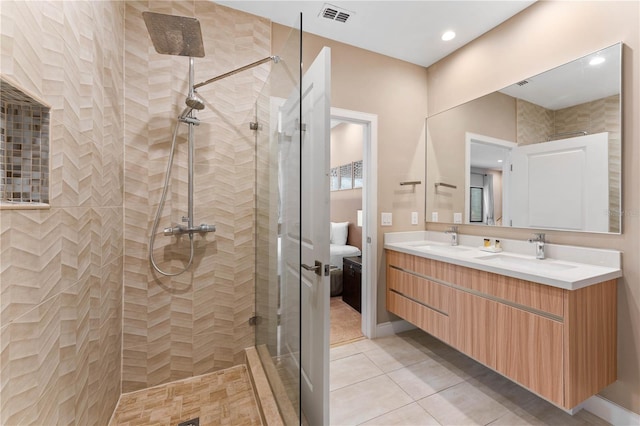 bathroom featuring dual vanity, tile floors, and a shower with shower door