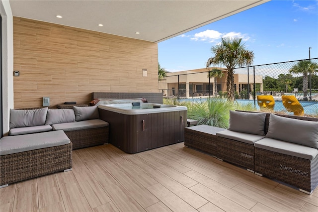 exterior space featuring outdoor lounge area and a hot tub