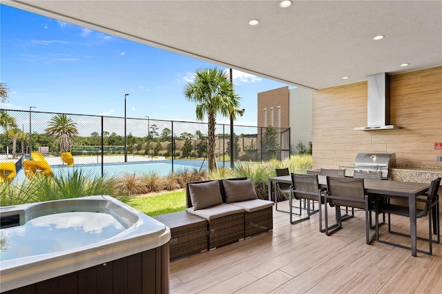 deck featuring a grill, an outdoor living space, and a hot tub