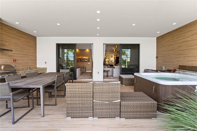 interior space featuring a grill, a hot tub, and a patio area