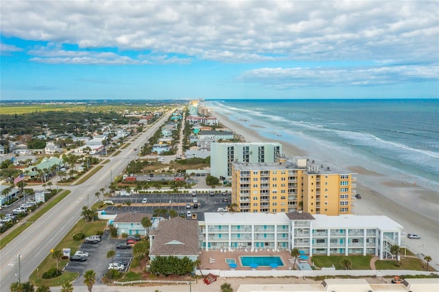 drone / aerial view featuring a beach view and a water view