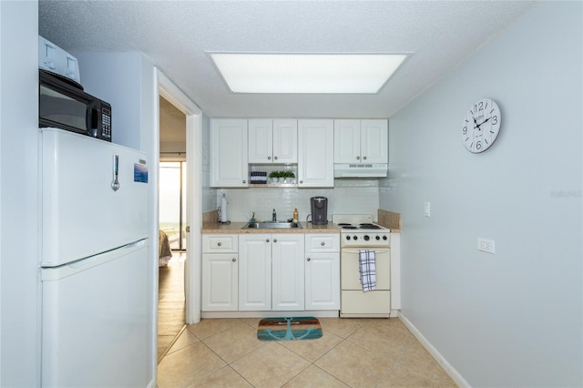 kitchen with white appliances, sink, light tile floors, white cabinets, and tasteful backsplash