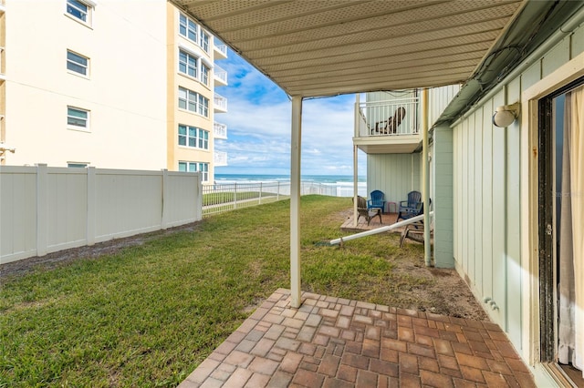 view of yard featuring a balcony, a water view, and a patio area