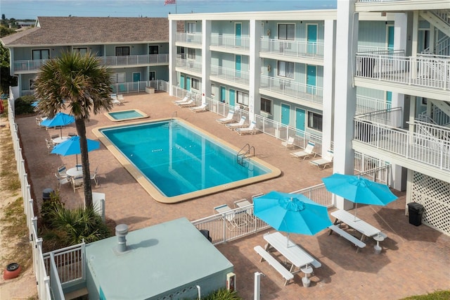 view of pool with a patio area and a hot tub