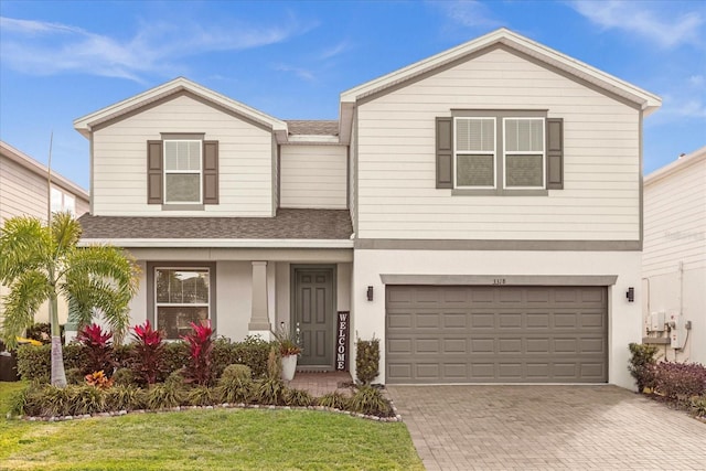 view of front of home featuring a front lawn and a garage